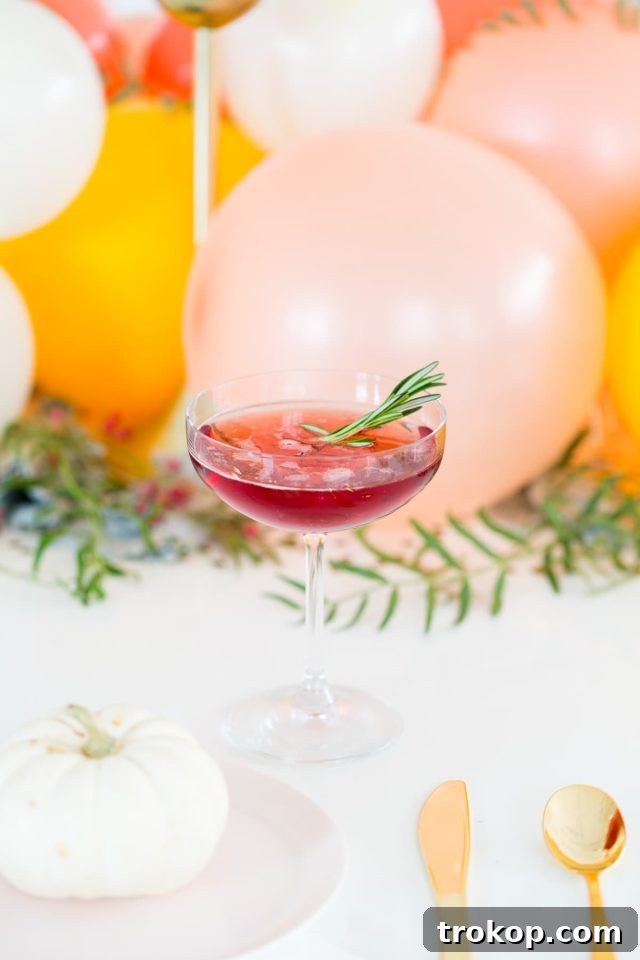 Pouring the Blackberry Blitz cocktail mixture into a glass