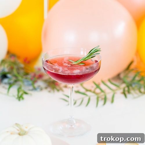 Blackberry Blitz Cocktail served in a coupe glass on a Friendsgiving table