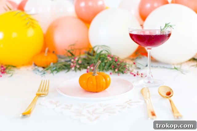 Beautiful Friendsgiving table setting featuring a DIY balloon centerpiece, ready for guests