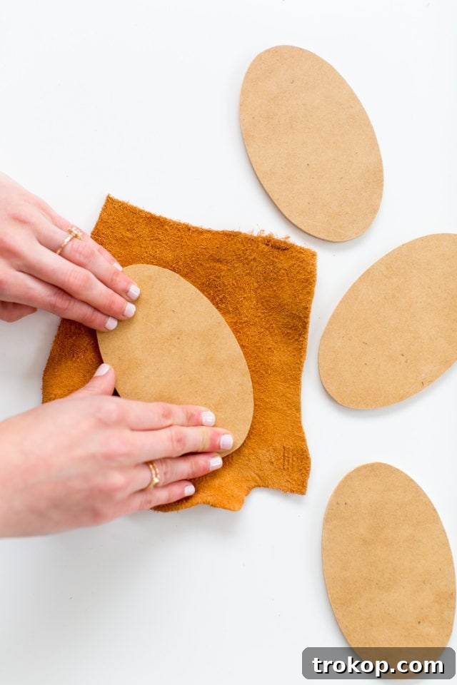 Kick Off Your Table with DIY Football Coasters and Mats 6 Pressing leather onto a glued oval wood cutout for a football coaster