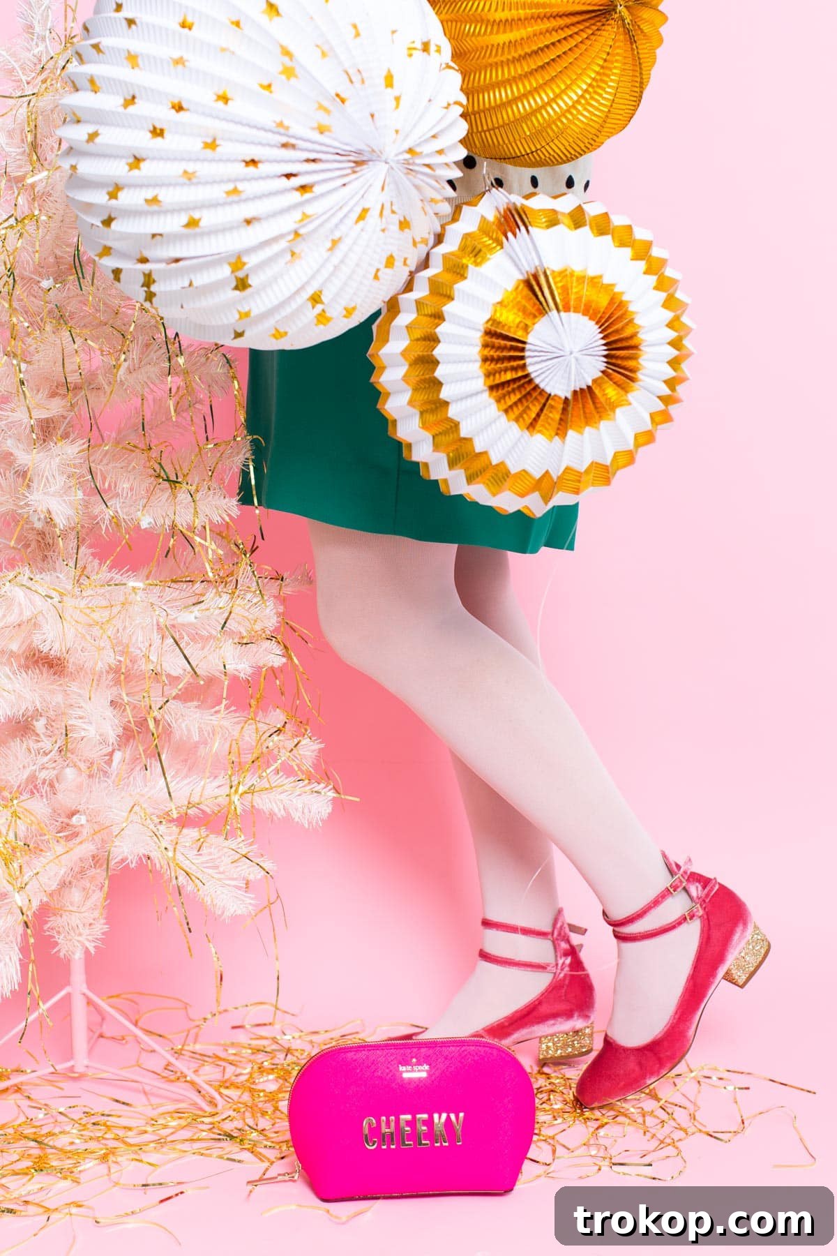 Two personalized Kate Spade bags with charms and a contrasting strap, set against a festive, snowy background.