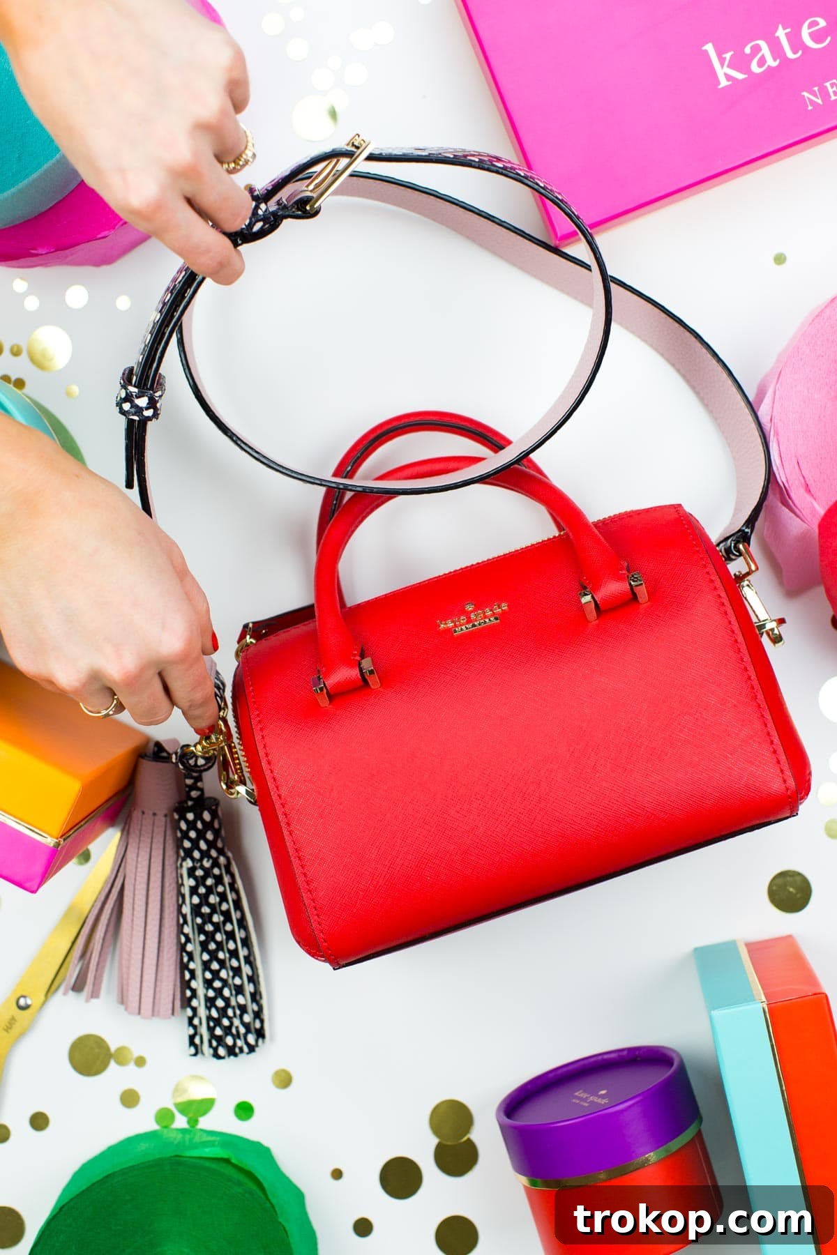 A red Kate Spade Cameron Street bag with a custom nude and polka dot strap, elegantly styled.