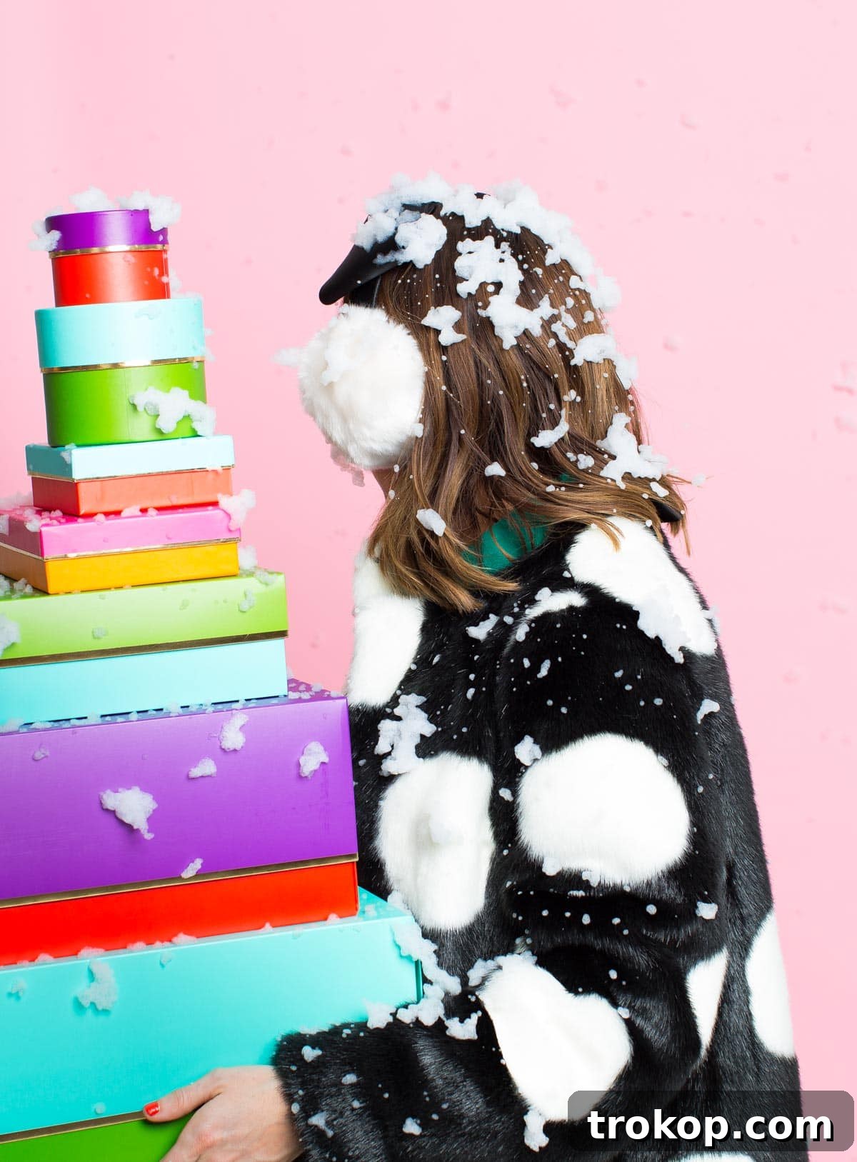 Kate Spade gift boxes artfully arranged on a snowy surface, showcasing festive personalized accessories.