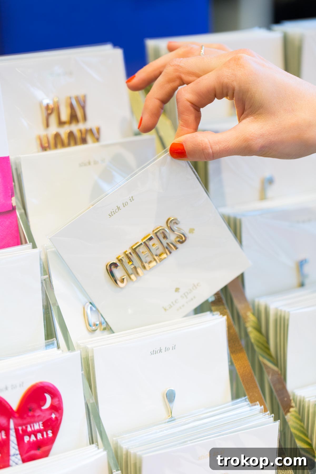 A selection of elegant Kate Spade accessories, including a classic handbag and wallet, ready for personalization.