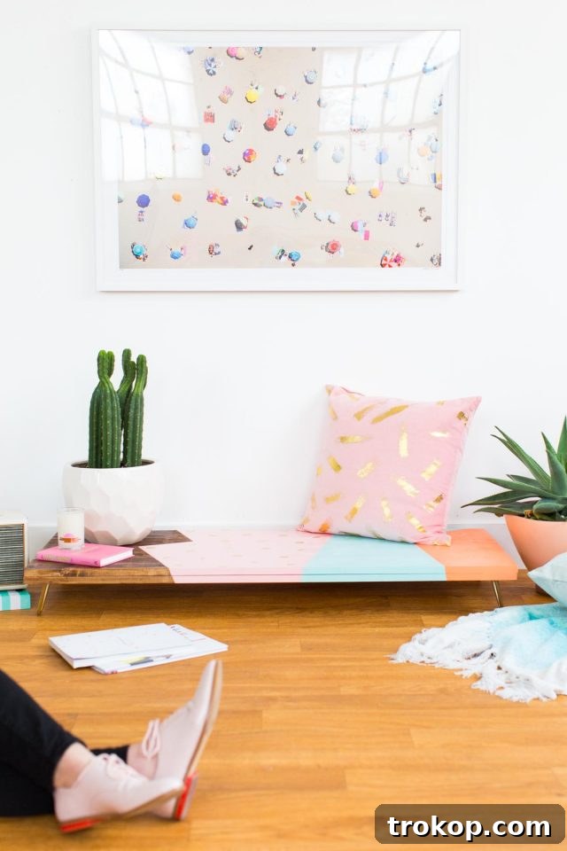 A stunning DIY modern low bench with an abstract, colorful design and elegant hairpin legs, created by lifestyle and DIY enthusiast Ashley Rose of Sugar & Cloth.