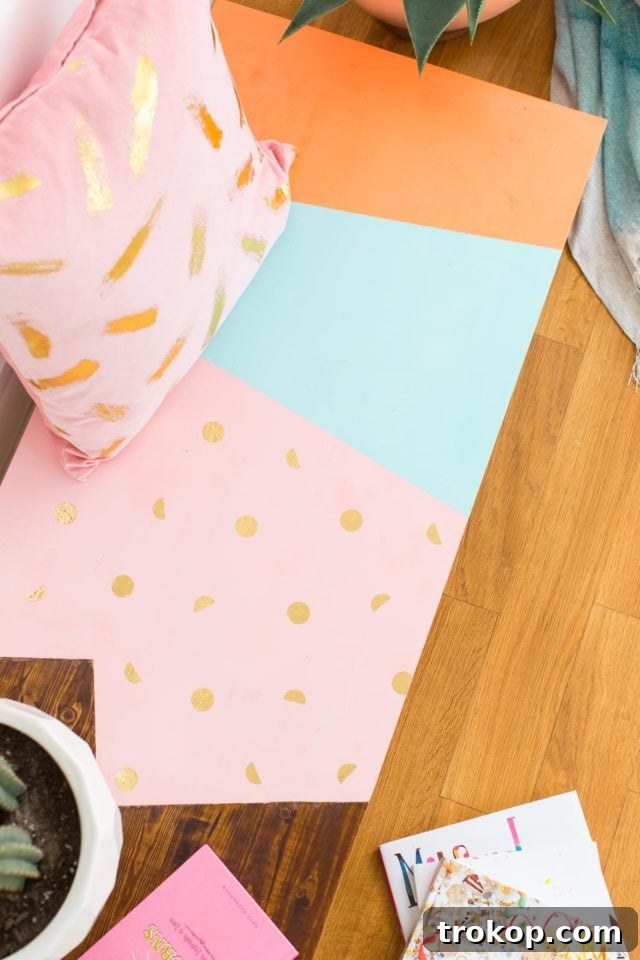 Ashley Rose of Sugar & Cloth showcasing her abstract modern DIY low bench with a colorful, geometric design.