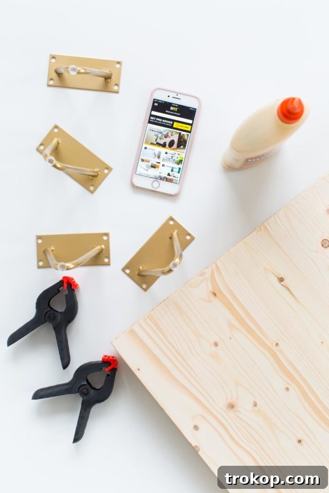 Essential tools and materials laid out for constructing a DIY modern low bench, including wood boards, drill, and clamps.