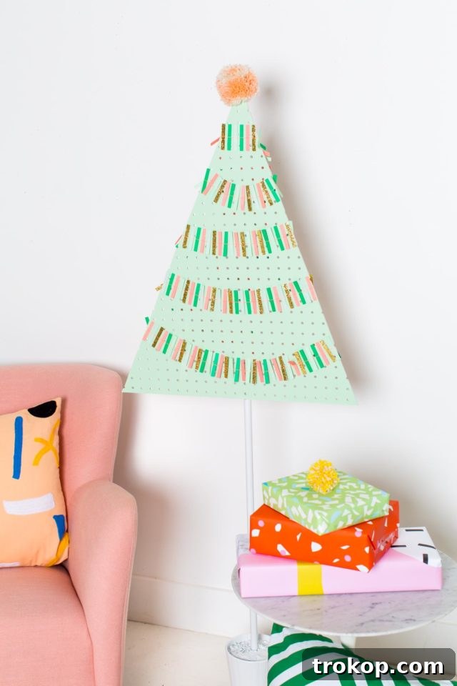 Craft a Modern Pegboard Christmas Tree 2 A vibrant and colorful DIY Pegboard Christmas Tree, decorated with festive ornaments, standing tall as a modern holiday decor piece.