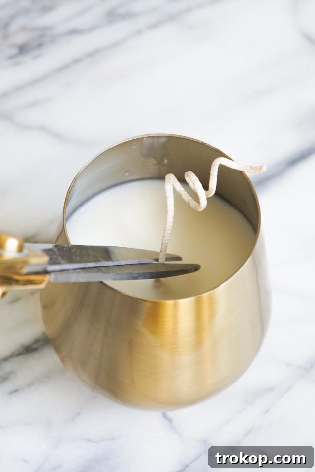 A finished essential oil candle with the wick trimmed, ready for burning.