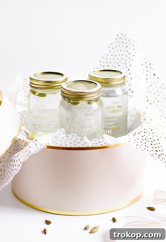 A festive bottle of ginger infused gin, ready for gifting, set against a cozy holiday backdrop. This homemade holiday gift is perfect for cocktail enthusiasts.