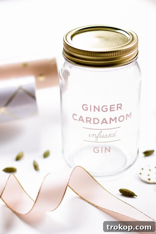 A beautifully labeled mason jar filled with homemade ginger infused gin, showcasing the ideal presentation for a thoughtful holiday gift. Perfect for DIY gifting.
