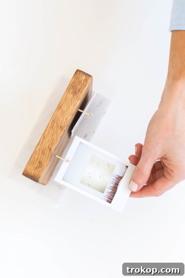 Craft Your Own Flip Photo Book 9 Finished DIY Flip Photo Album with Instax photos hanging on shoulder hooks, displayed on a desktop.