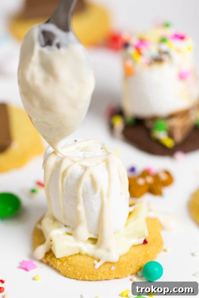 Drizzling melted chocolate on toasted marshmallows for festive s'mores