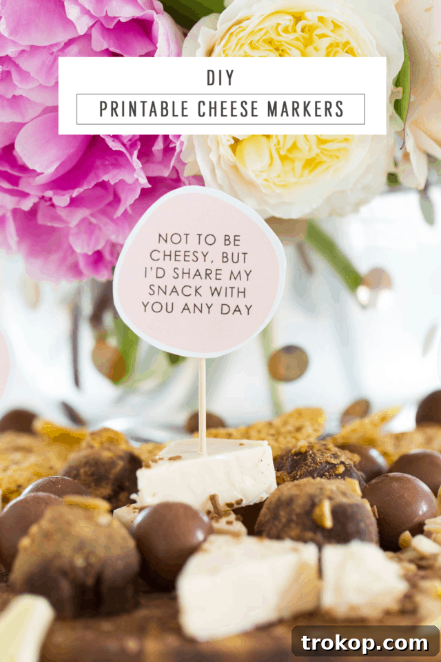 A selection of DIY cheese board markers featuring various humorous and affectionate messages like 'Let's Get Cheesy' and 'I'm Fondue You', arranged on a clean white background.
