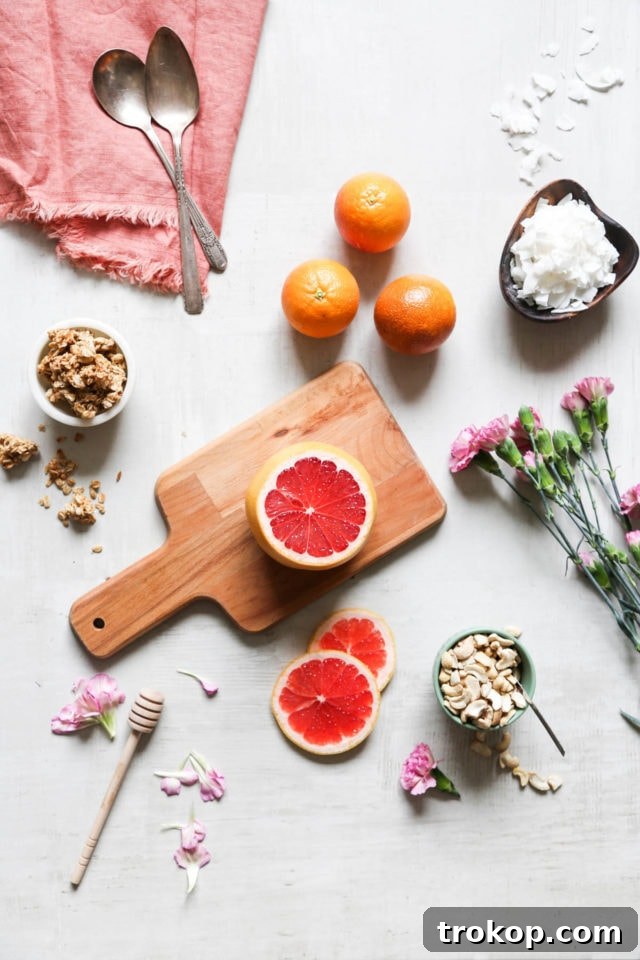 Overhead shot of fresh grapefruits and ingredients ready for making Winter Citrus Smoothies. A DIY food project by Sugar & Cloth.
