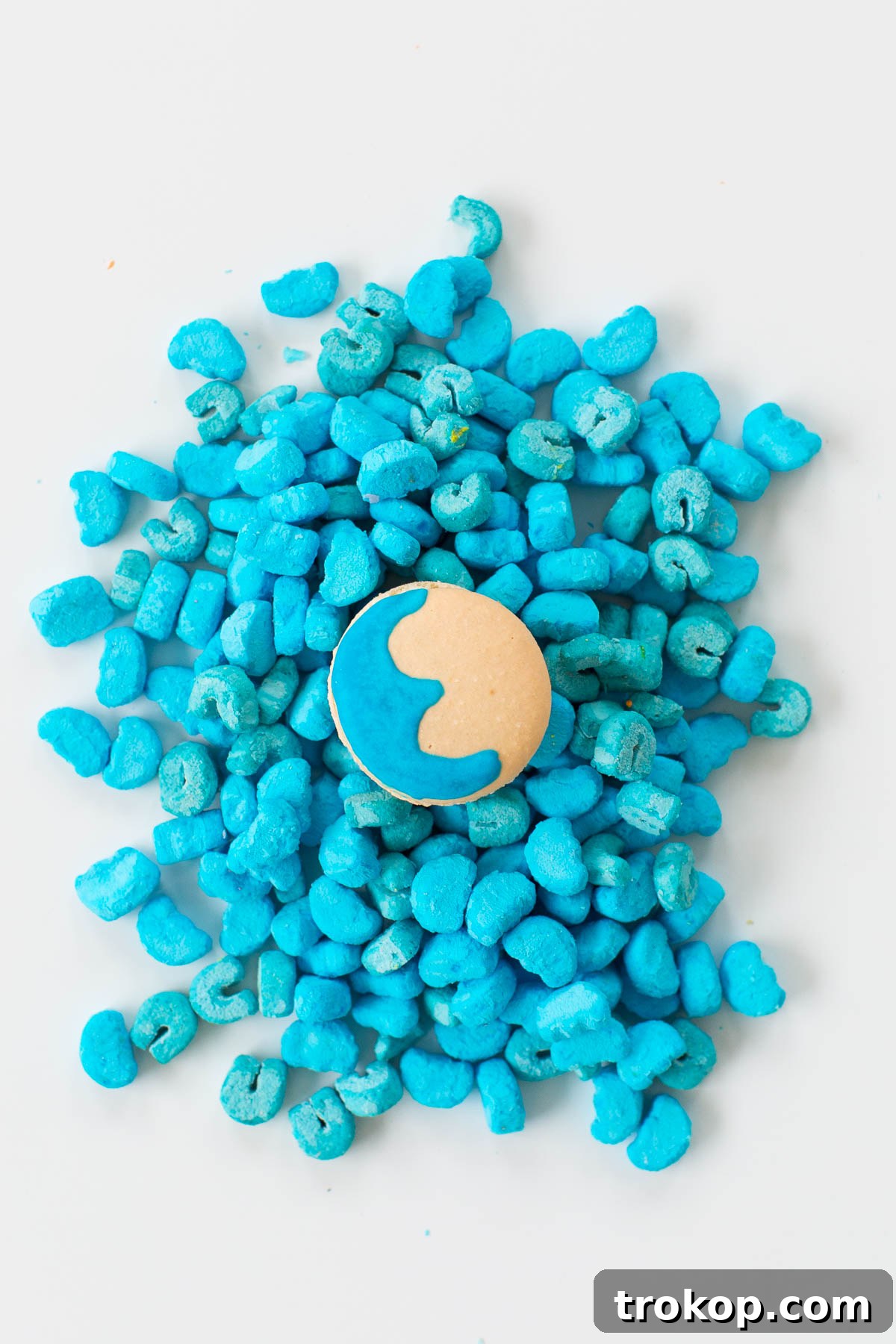 Another perspective of DIY Lucky Charms Macarons, showcasing their playful design on a bed of marshmallows. Image courtesy of Ashley Rose of Sugar and Cloth.