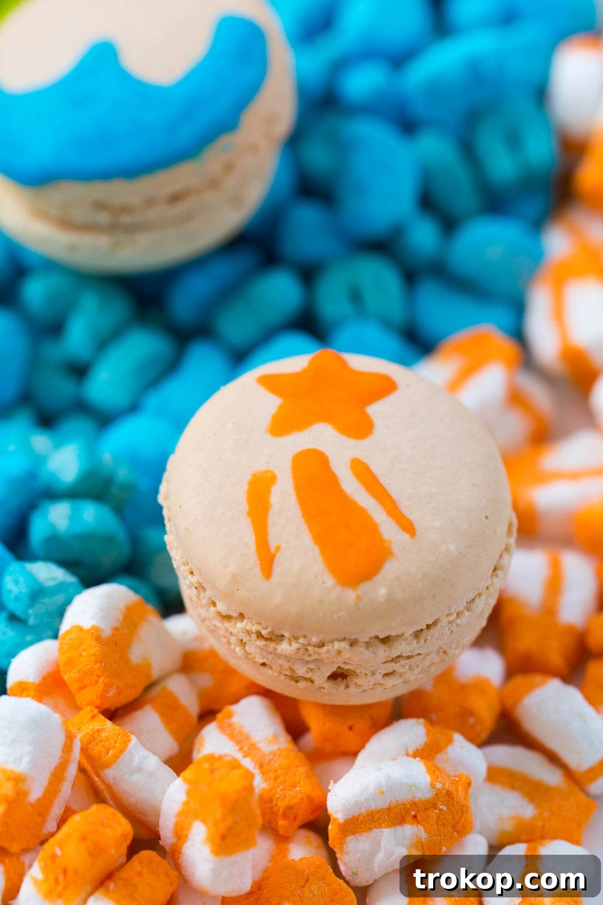 Close-up of a macaron shell with a distinct purple horseshoe design, adding another classic Lucky Charms element.