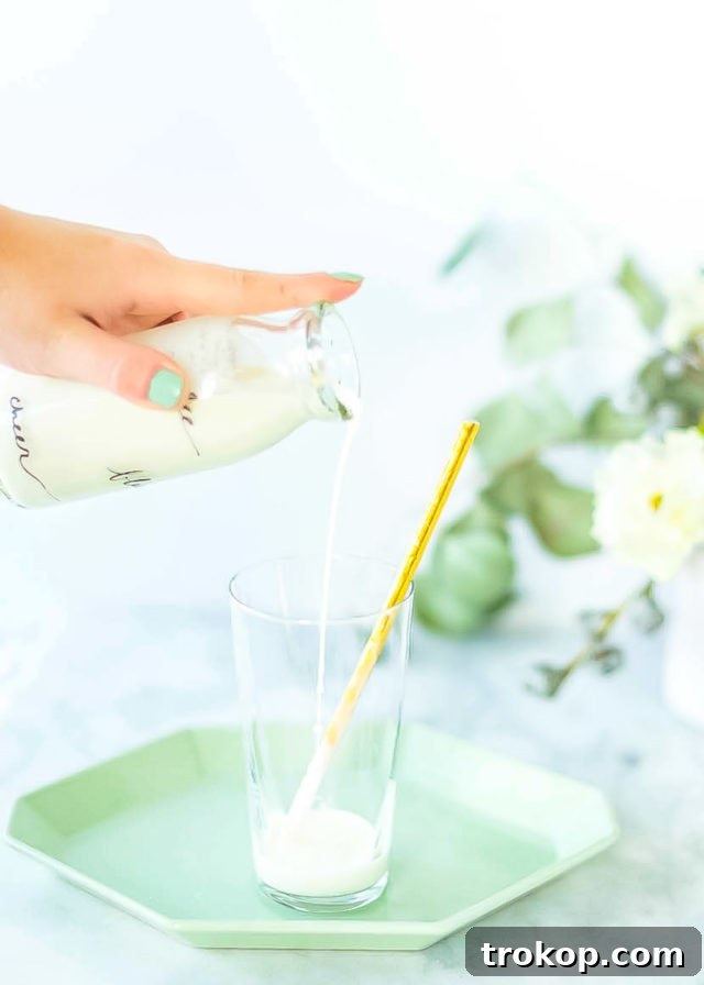 A refreshing Boozy Cereal Milk Egg Cream, showcasing its creamy texture and frothy top, ready to be enjoyed.
