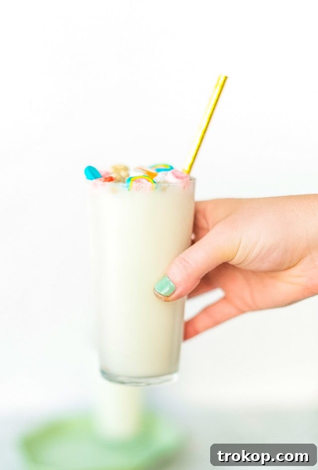 A selection of ingredients for making Boozy Cereal Milk Egg Cream, including Lucky Charms, cream, vodka, and soda water.