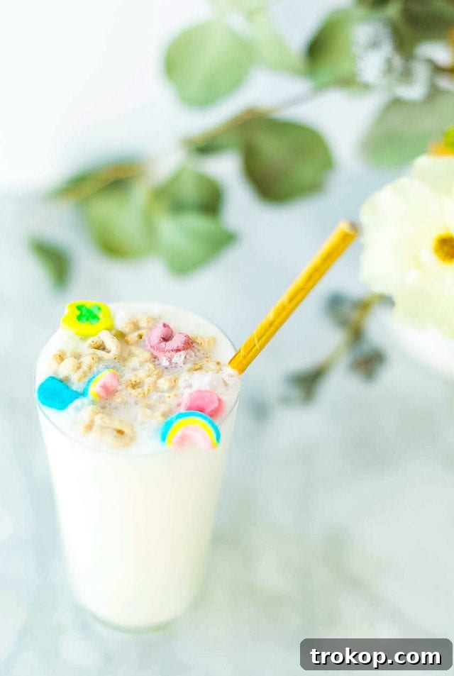 Another perspective of the Boozy Cereal Milk Egg Cream, highlighting the vibrant colors and creamy foam.