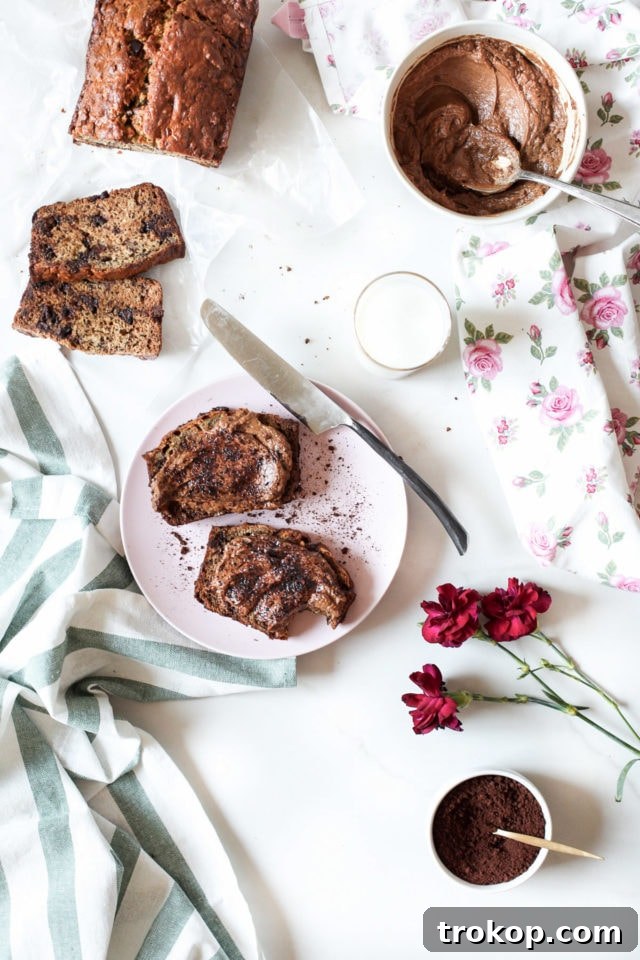 A perfectly sliced piece of chocolate chip banana bread, elegantly topped with creamy mocha mascarpone.