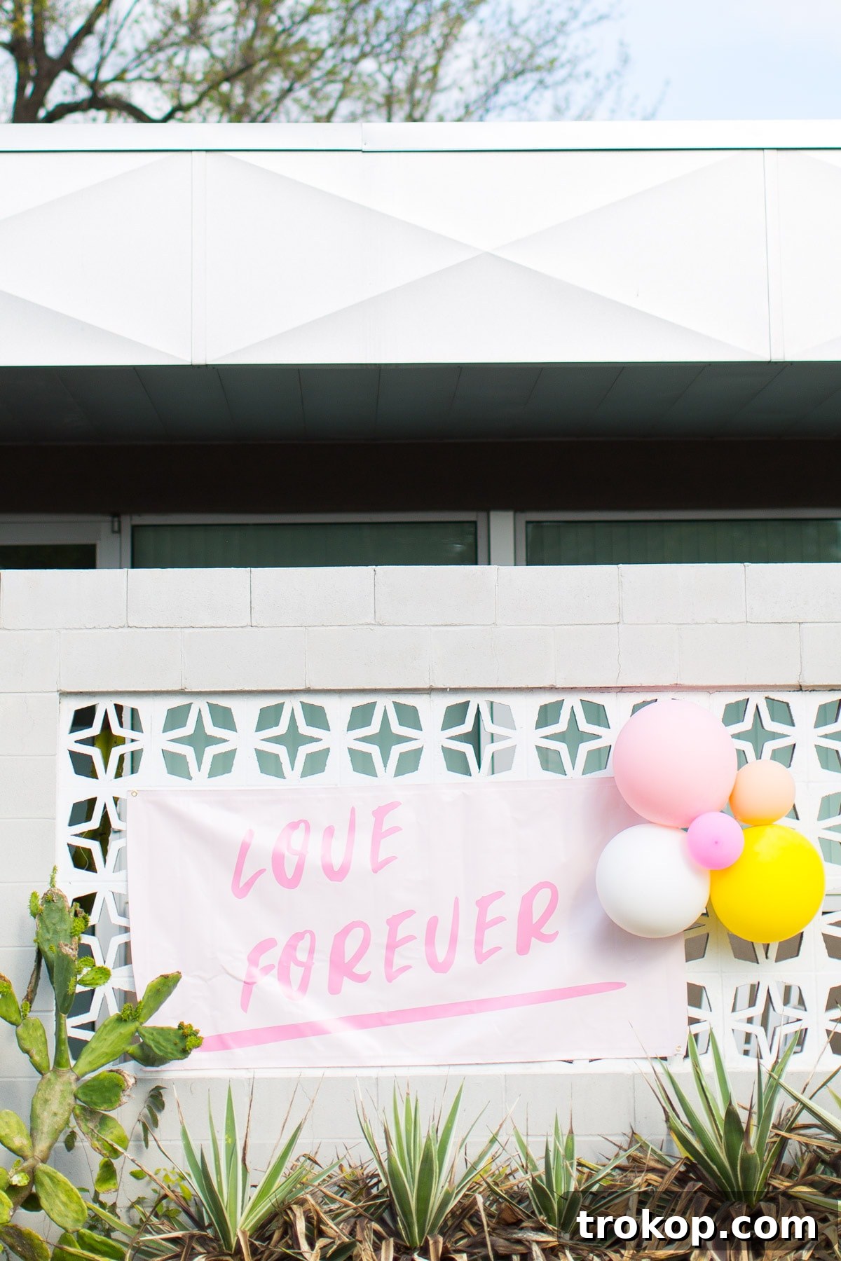 Mounted DIY printable 'Group Hug' poster by Sugar & Cloth placed in a public, urban setting