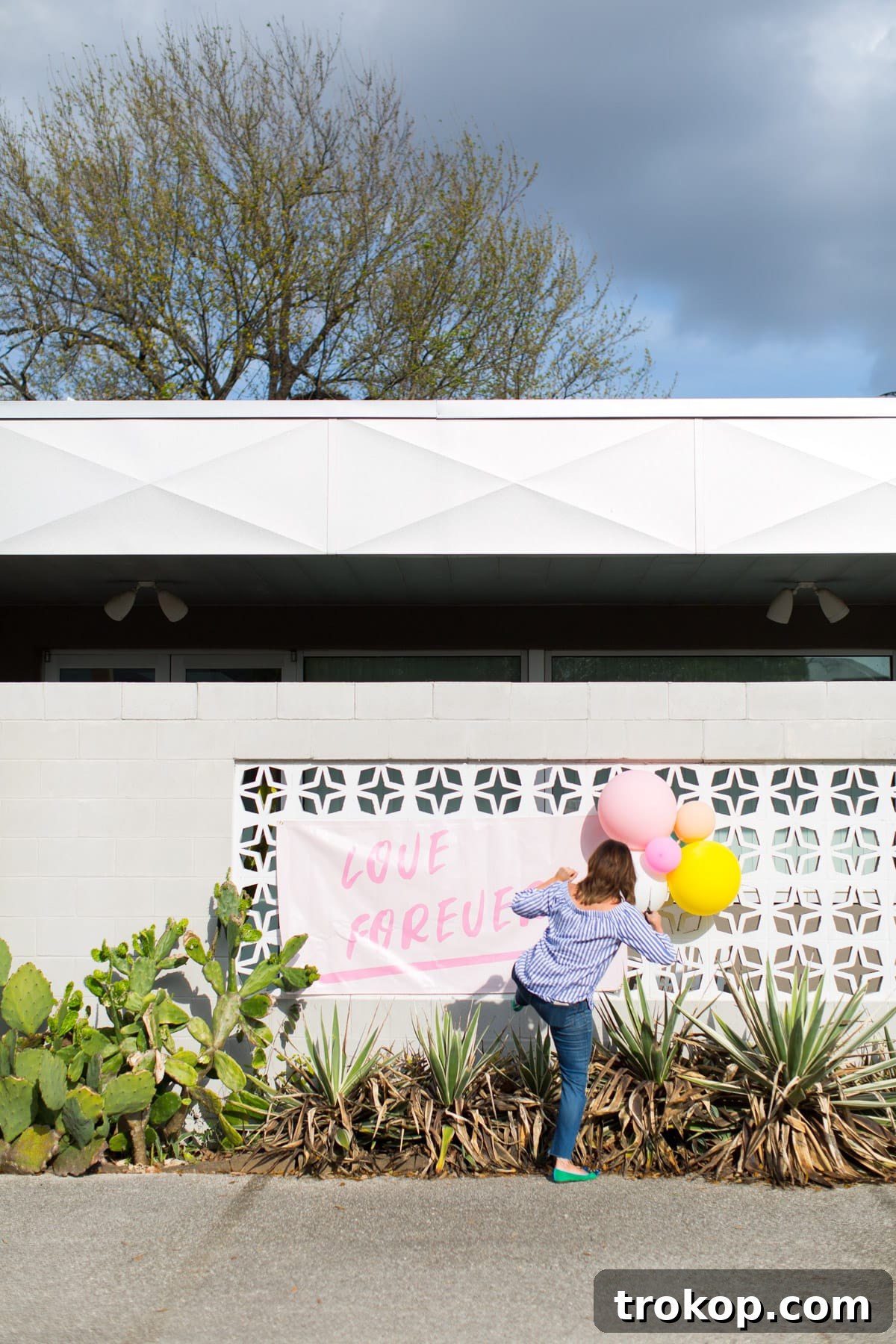 Giant 'Love Forever' DIY printable banner by Sugar & Cloth displayed on an exterior wall in Houston
