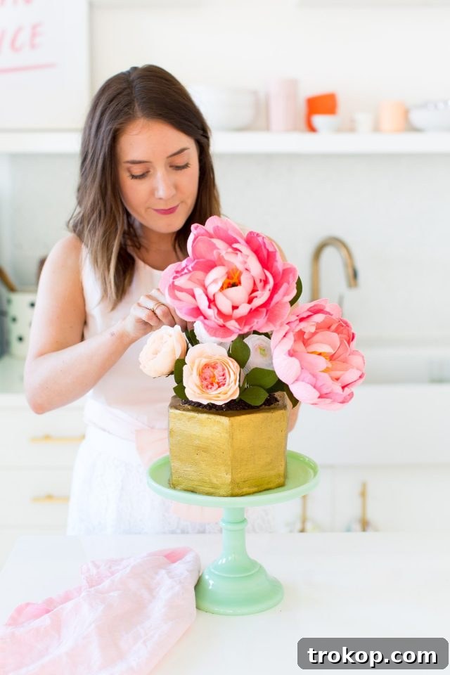 Sweet Flower Pot Cake Secrets 11 A close-up of the flower pot cake, focusing on the vibrant crepe paper flowers and the textural details of the edible soil, hinting at the delightful surprise within.