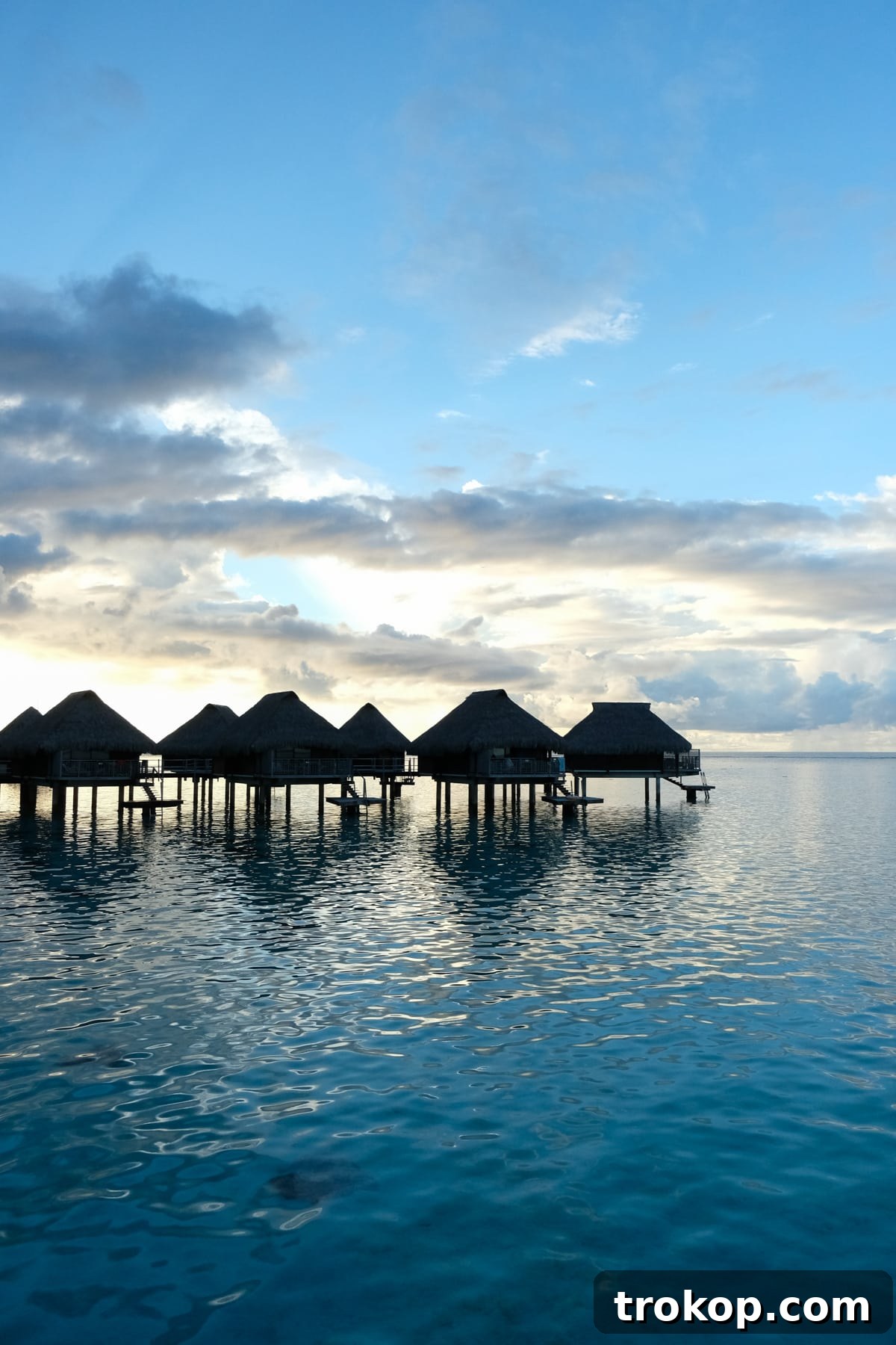 Overwater bungalow walkway at night in Moorea