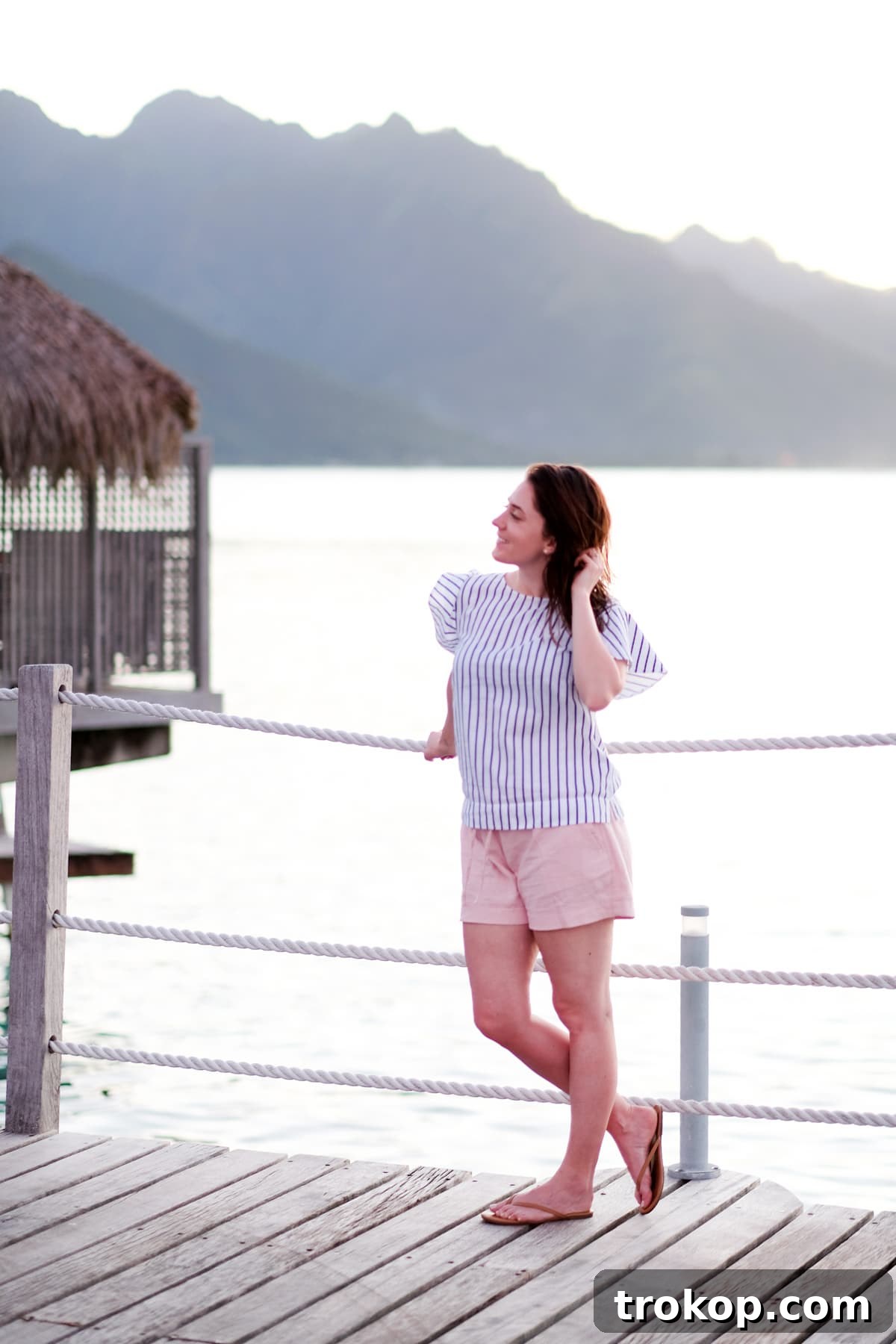 Couple embracing on a hammock over the water in Moorea