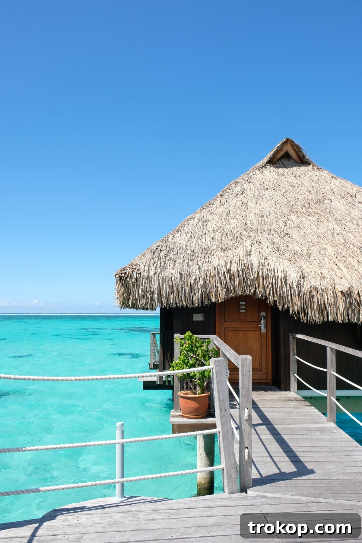 Couple enjoying breakfast at their overwater bungalow in Moorea