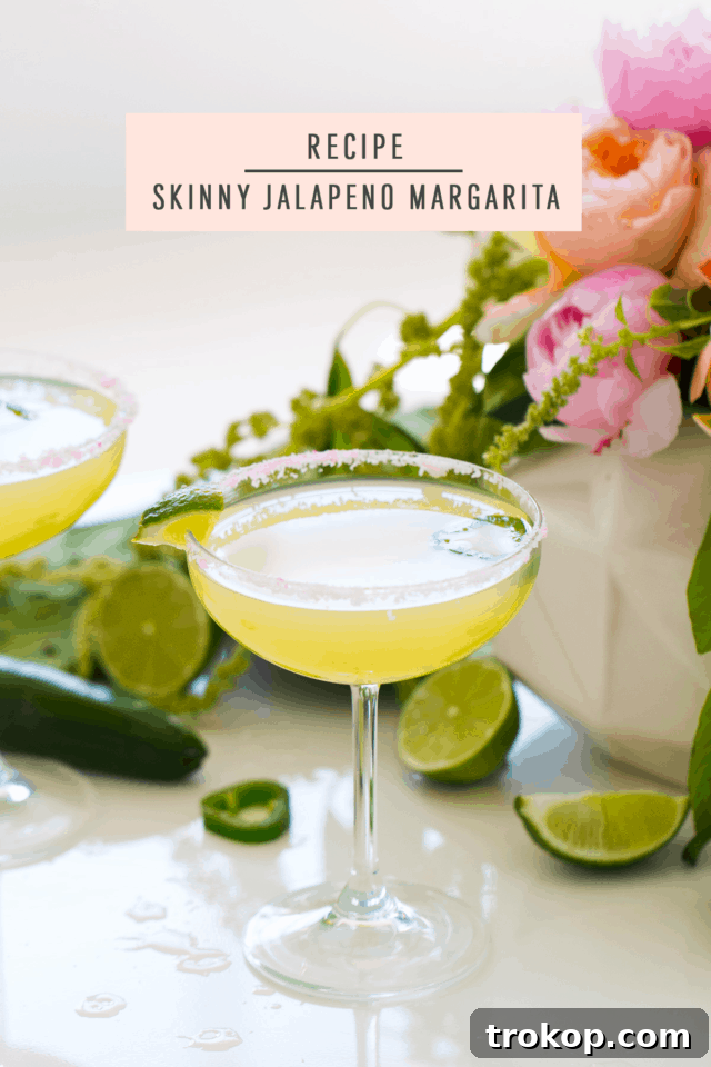 An overhead shot of a skinny jalapeño margarita, showing the vibrant colors and garnishes