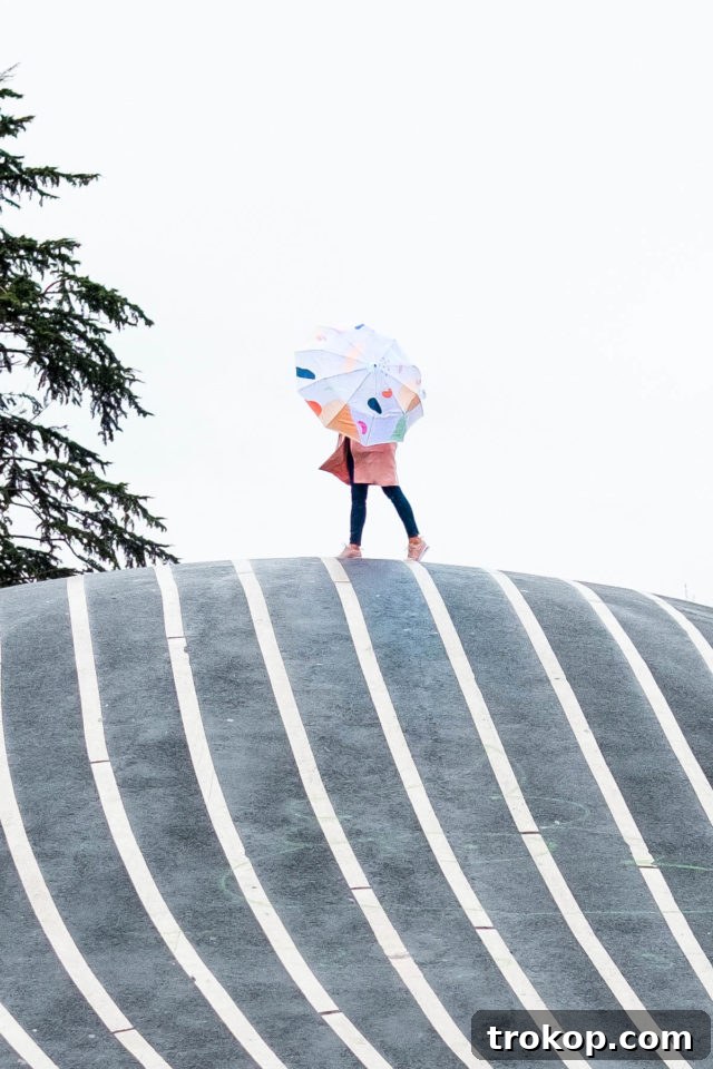 Finished DIY abstract painted umbrella, showcasing vibrant colors and unique design against a neutral background