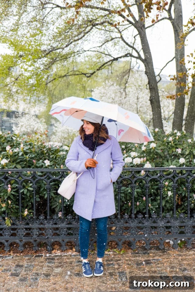 Stylishly painted abstract umbrella being held open against a bright, sunny background