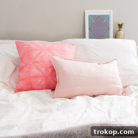 Finished DIY Pink Shibori Throw Pillow, showing the intricate dye patterns on soft fabric