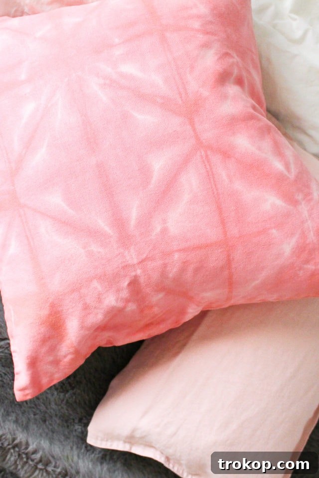 Craft Your Own Shibori Tie Dye Pillow 10 Close-up detail of a finished DIY Pink Shibori Throw Pillow, highlighting the unique textured pattern and soft pink hue