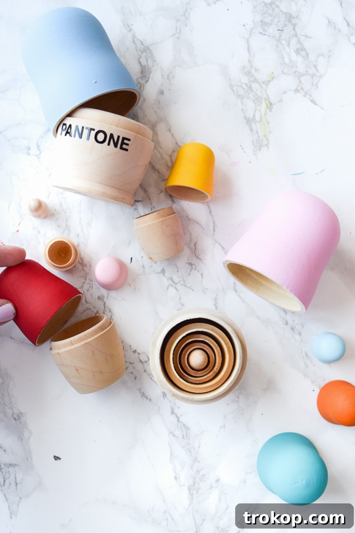 Close-up of a single DIY Pantone nesting doll, highlighting the smooth paint finish and precisely applied vinyl lettering, ready for display.