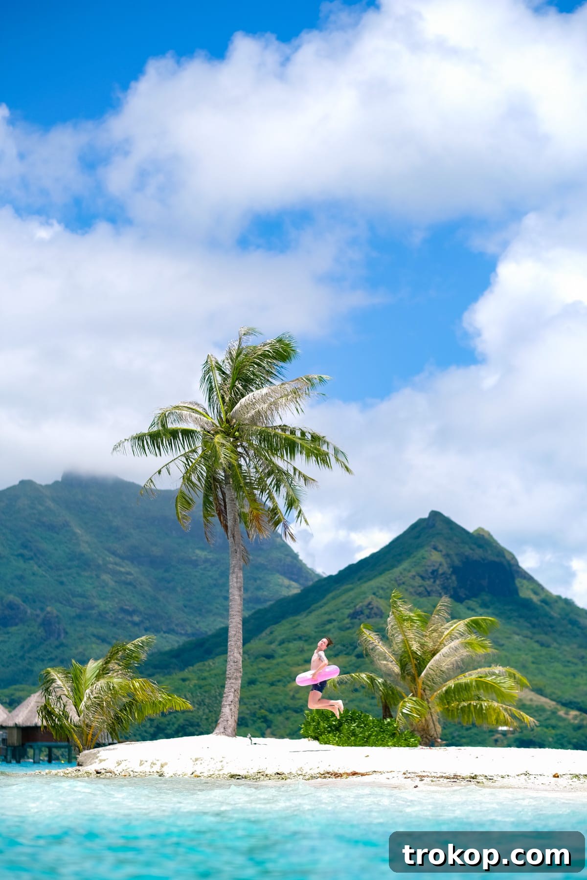 Couple enjoying a giant inflatable flamingo float in the Bora Bora lagoon