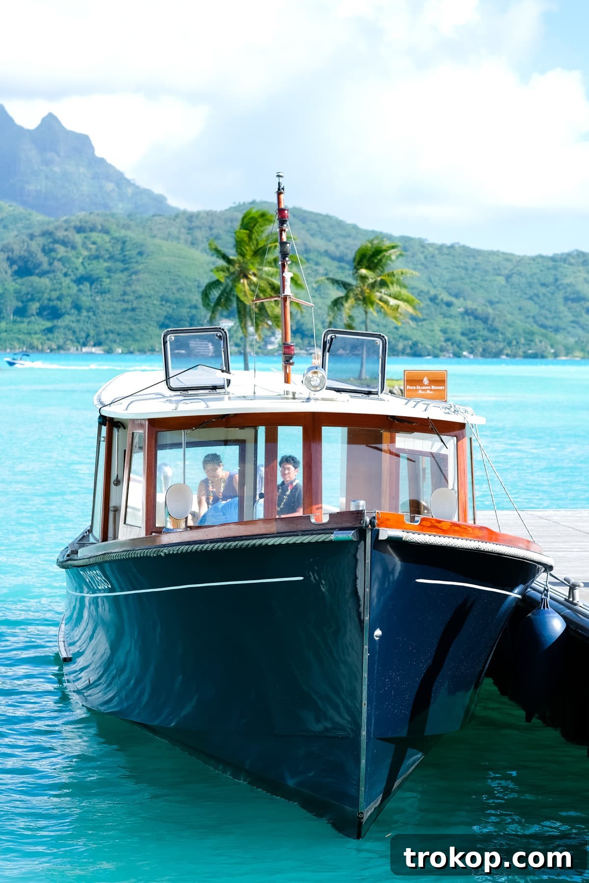 Newlywed couple arriving at Four Seasons Bora Bora via private boat transfer