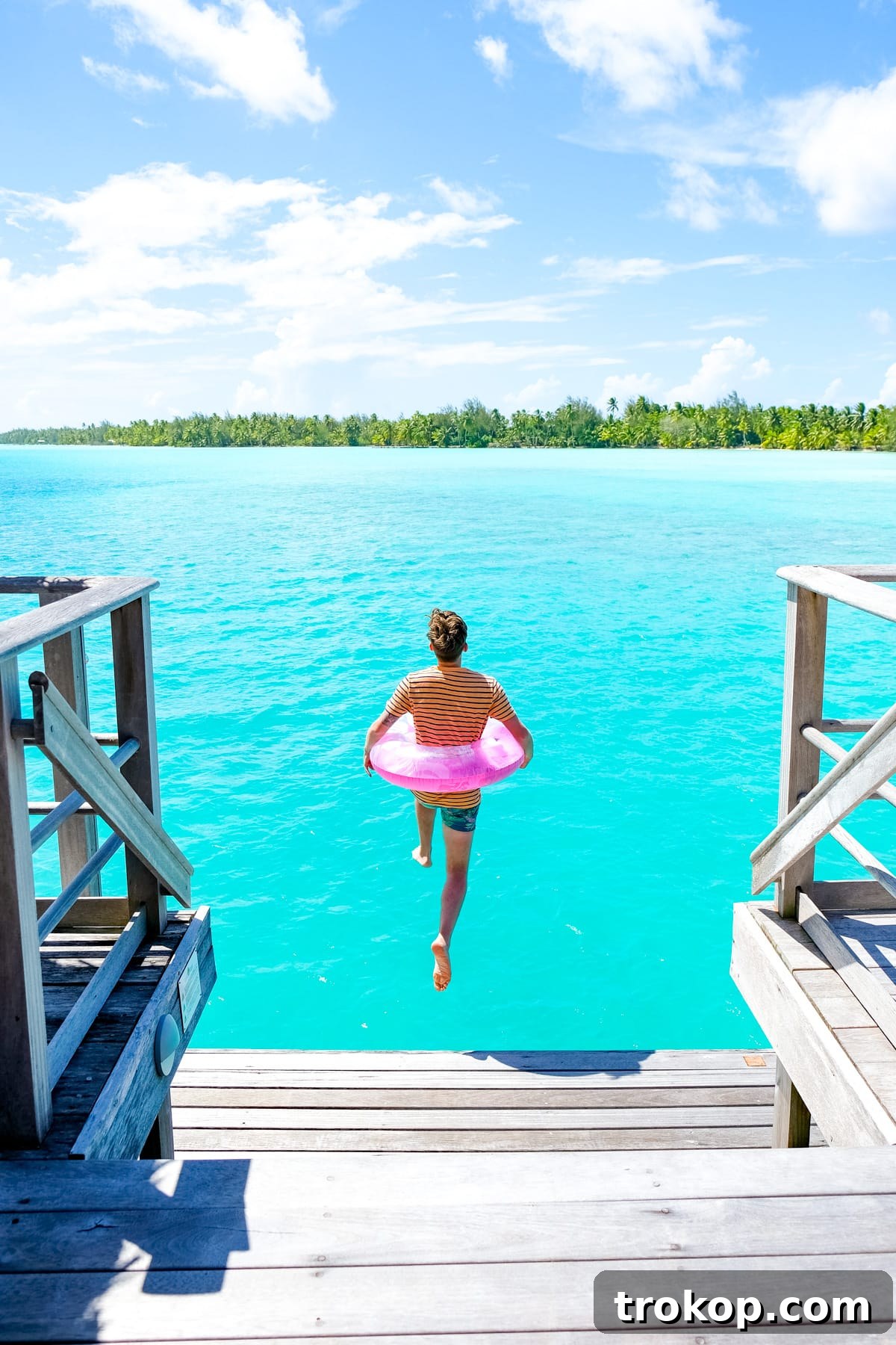 Four Seasons Bora Bora private transfer boat cruising on the crystal-clear lagoon