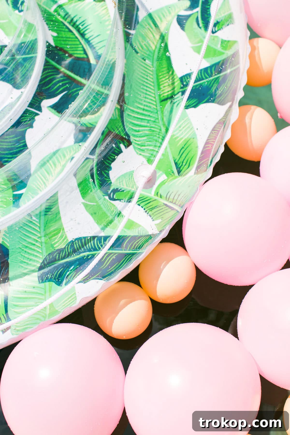 Opulent Poolside Soirees 5 Giant palm print pool float by Sunnylife, a key element for poolside fun.