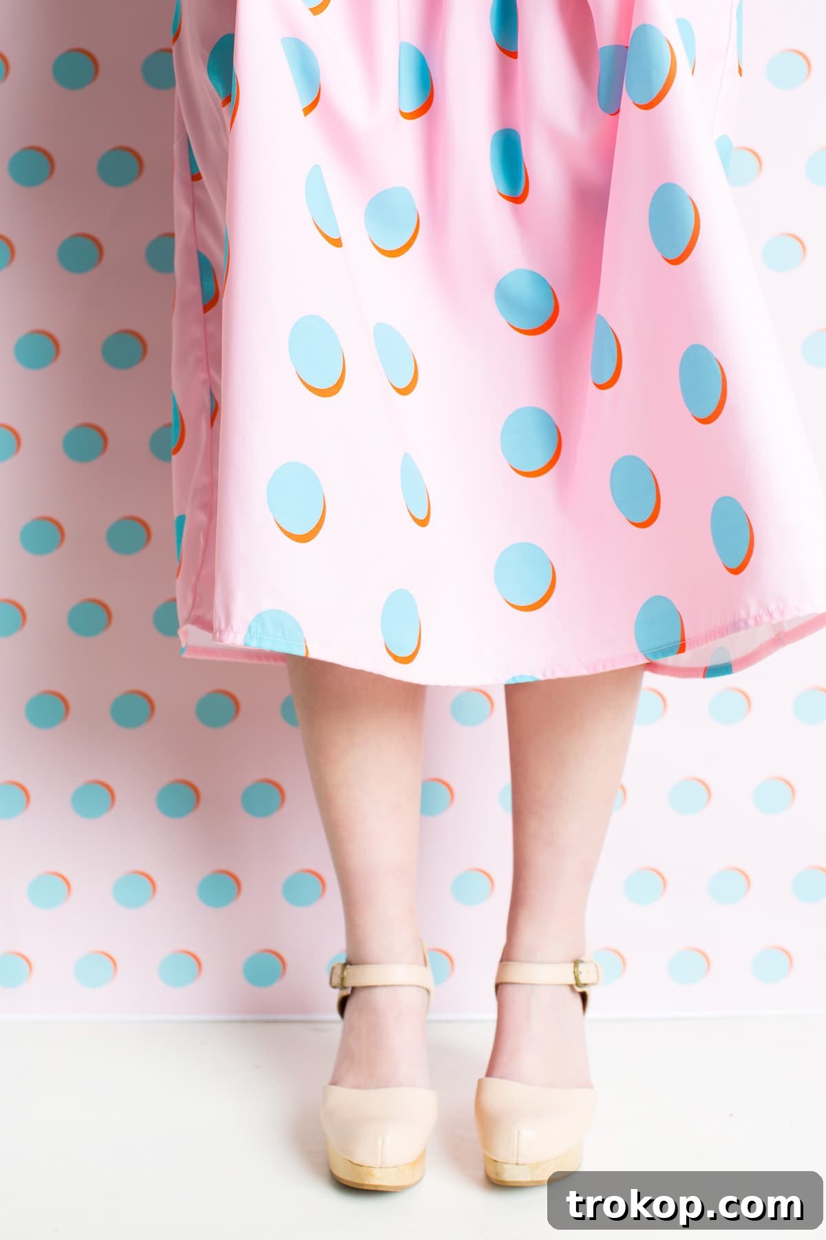 Guest in a custom polka dot dress at a patterned party
