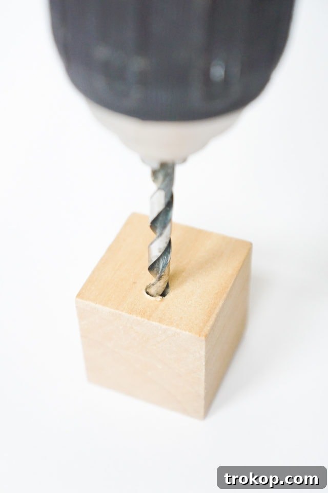 DIY Minimalist Flower Wall Hang: Step 2, drilling a hole through the wooden cube