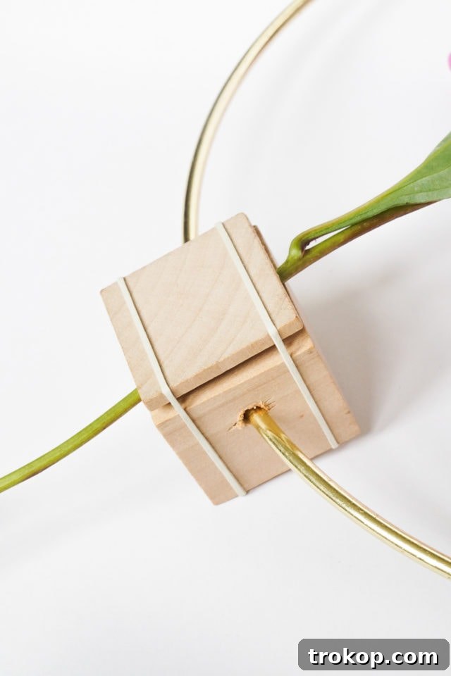 DIY Minimalist Flower Wall Hang: Step 5, inserting the flower stem into the wooden holder