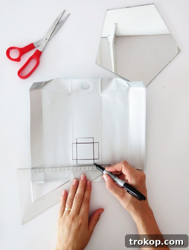 Measuring and drawing the concrete mold on a repurposed carton.