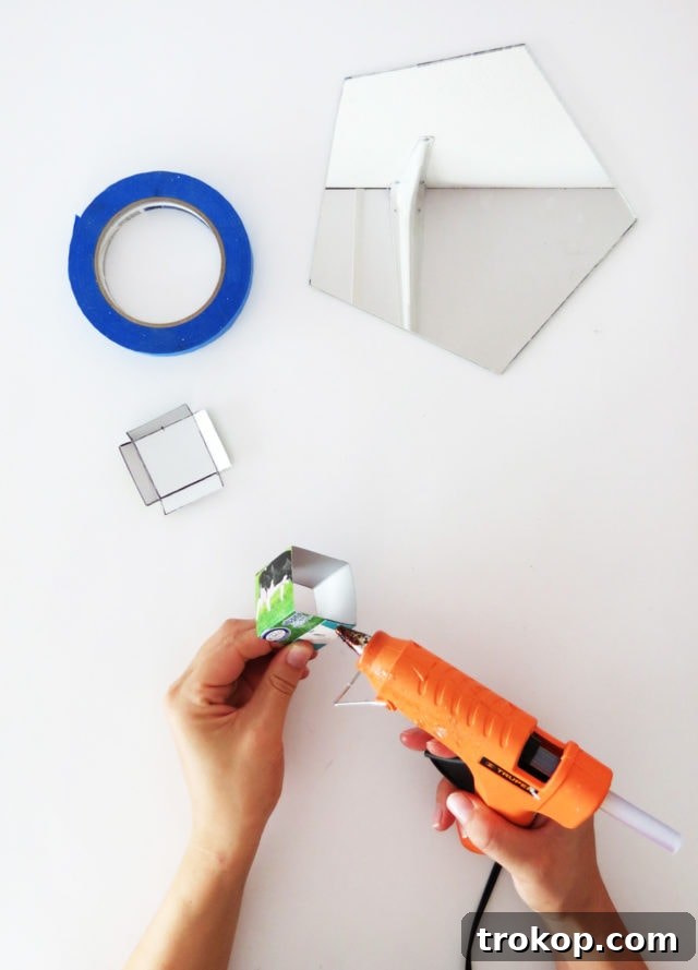 Assembling the concrete mold with hot glue, ensuring smooth interior.