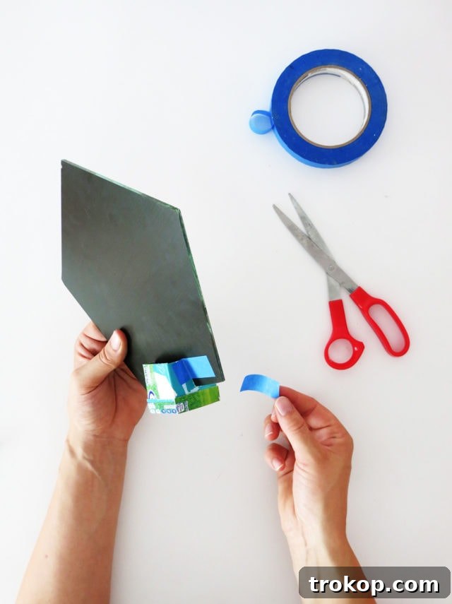 Securing the mirror in the mold with ample masking tape before pouring concrete.