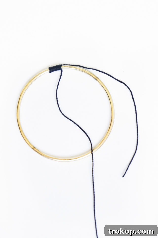 Step 1: Wrapping the main gold hoop with cotton flossing