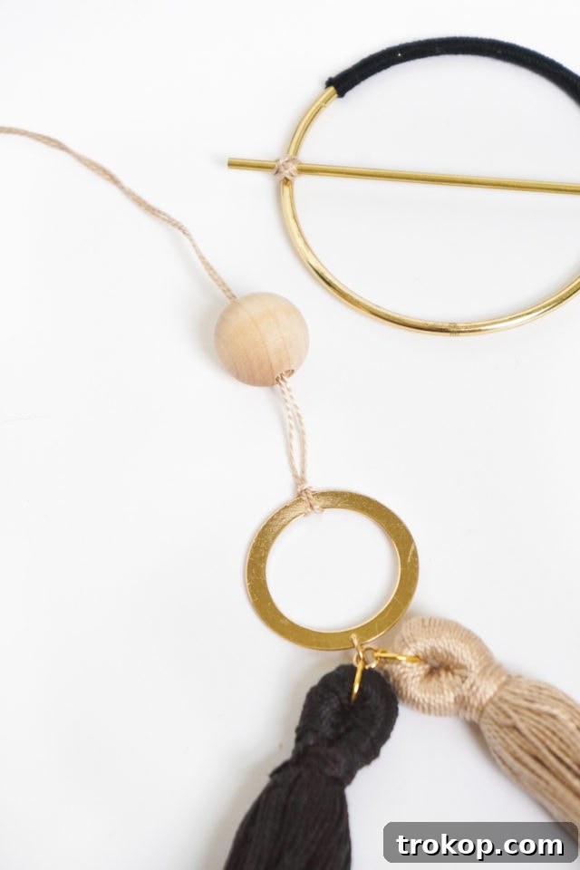 Step 5 & 6: Attaching flossing to a small circle, adding a wood bead, and connecting to the main hoop