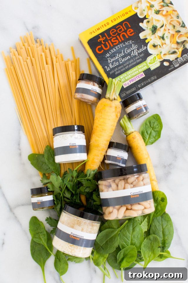 Fresh ingredients for the Roasted Garlic White Bean Alfredo recipe laid out on a clean kitchen surface.